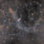 NGC 7497 + MBM 54, nubes moleculares sobre un campo de galaxias